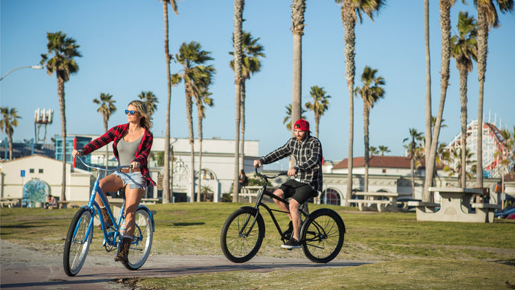 Couple riding beach cruisers